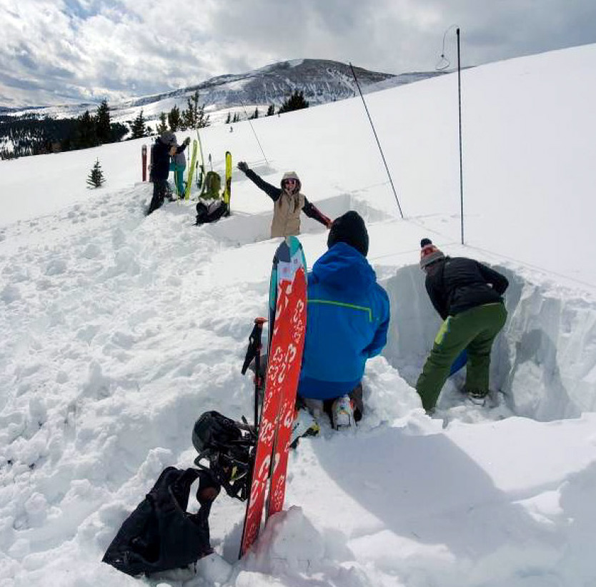 group digging pits during avalanche training