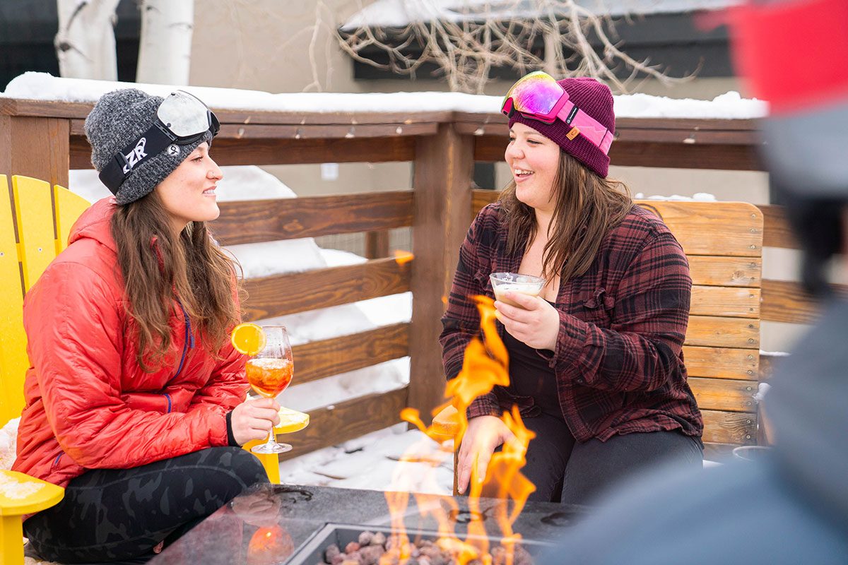 Allie Hughes with friend enjoying cocktails on the Gravity Haus Steamboat deck.