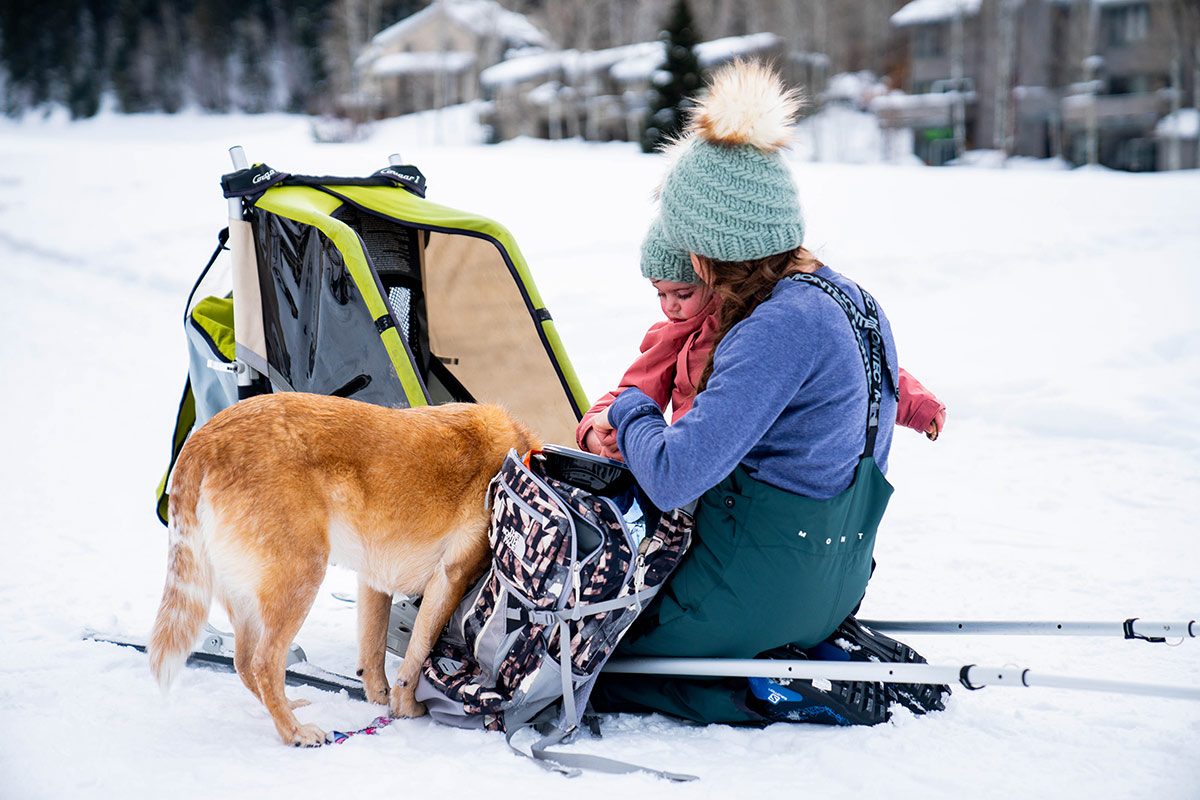 Coni Terrado with baby and dog getting ready for nordic skiing.