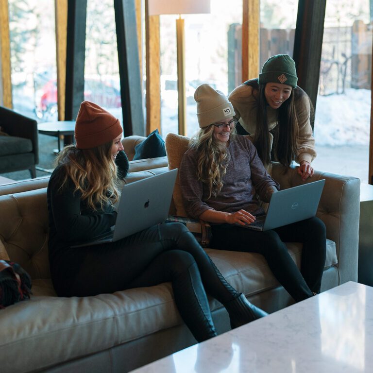 Three women collaborate in the StarterHaus Truckee Tahoe co-working space.