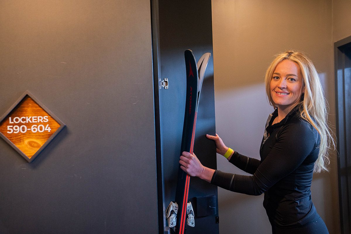 Rachel Carpenter getting her skis from a locker at Gravity Haus Breckenridge.
