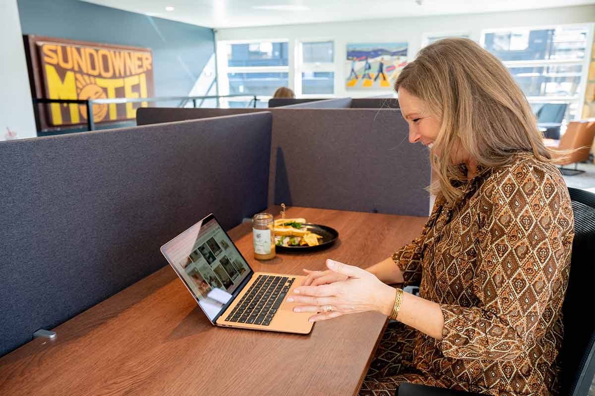 Kerry Crandell works on her laptop with a lunch plate at StarterHaus Winter Park