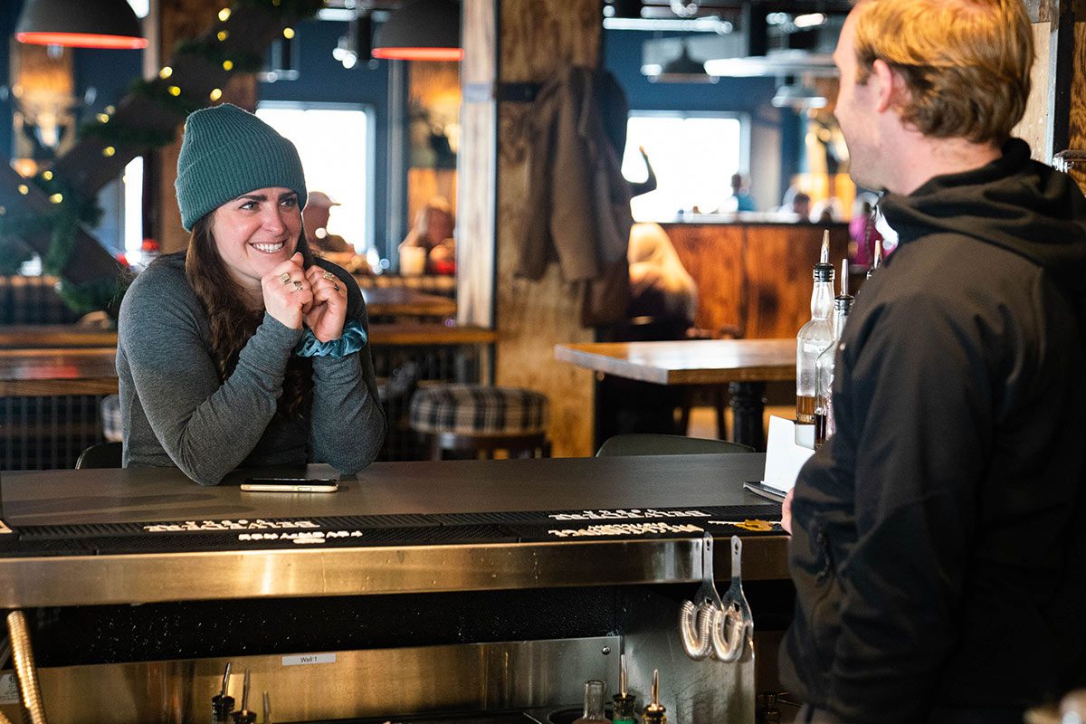 Andrea Rosenthal laughs with the bartender at Cabin Juice.