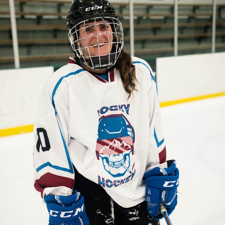 Andrea Rosenthal in hockey gear on the ice rink.