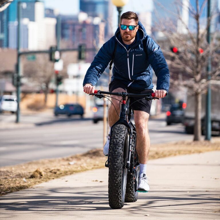 Ross Shuket rides a fat tire mountain bike on the streets of Denver on his way to Gravity Haus
