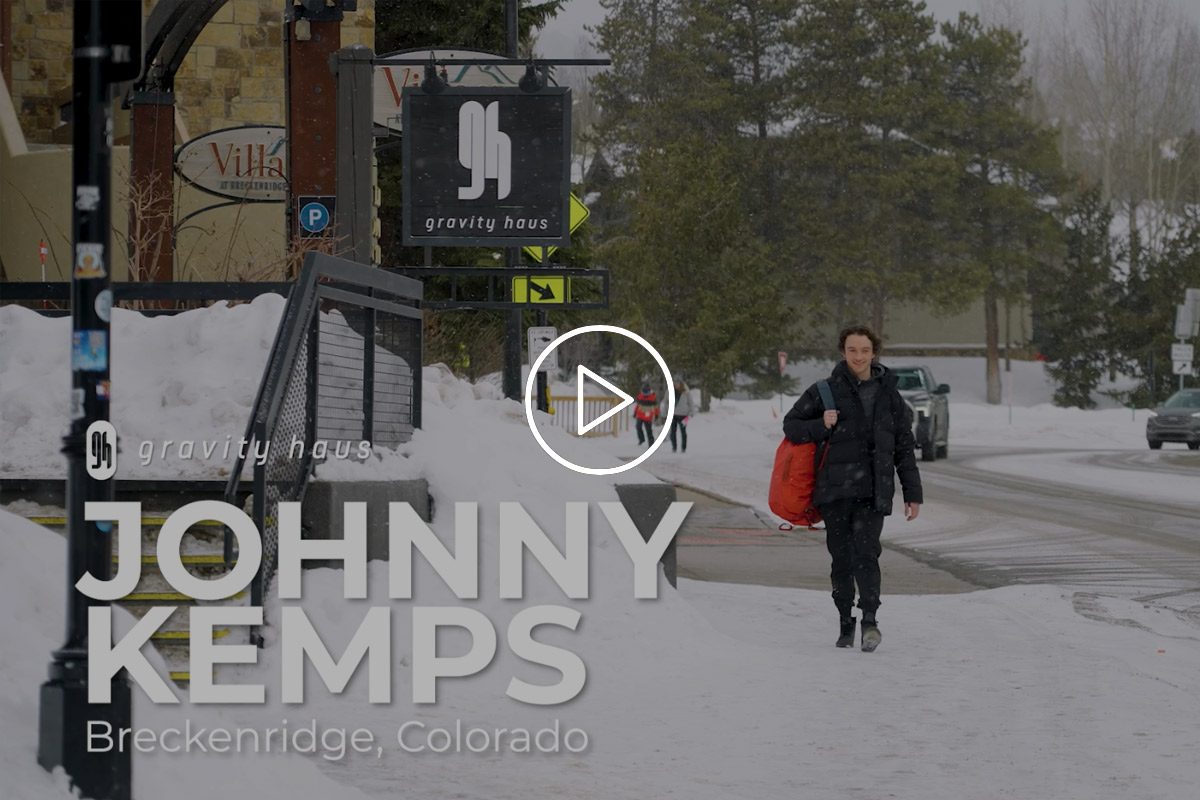 Johnny Kemps walking down snowy street next to Gravity Haus Breckenridge