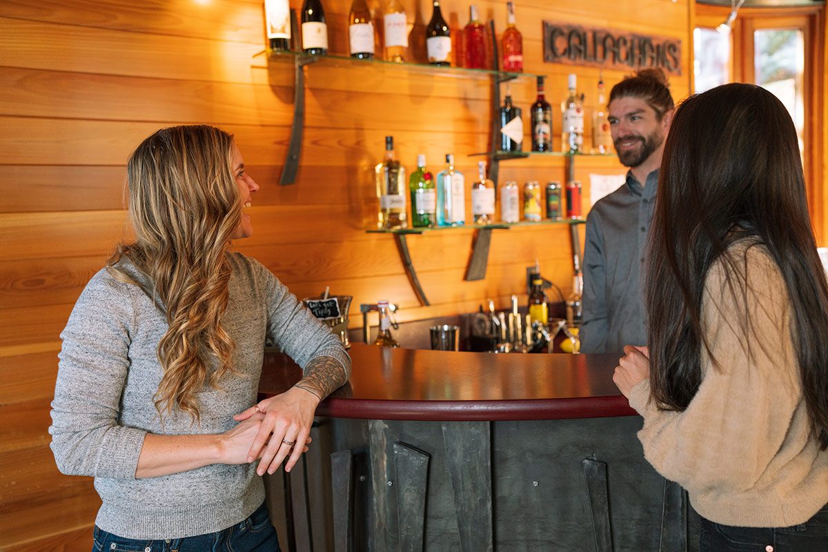 Guests chatting with bartender at Callaghans inside Gravity Haus Truckee-Tahoe